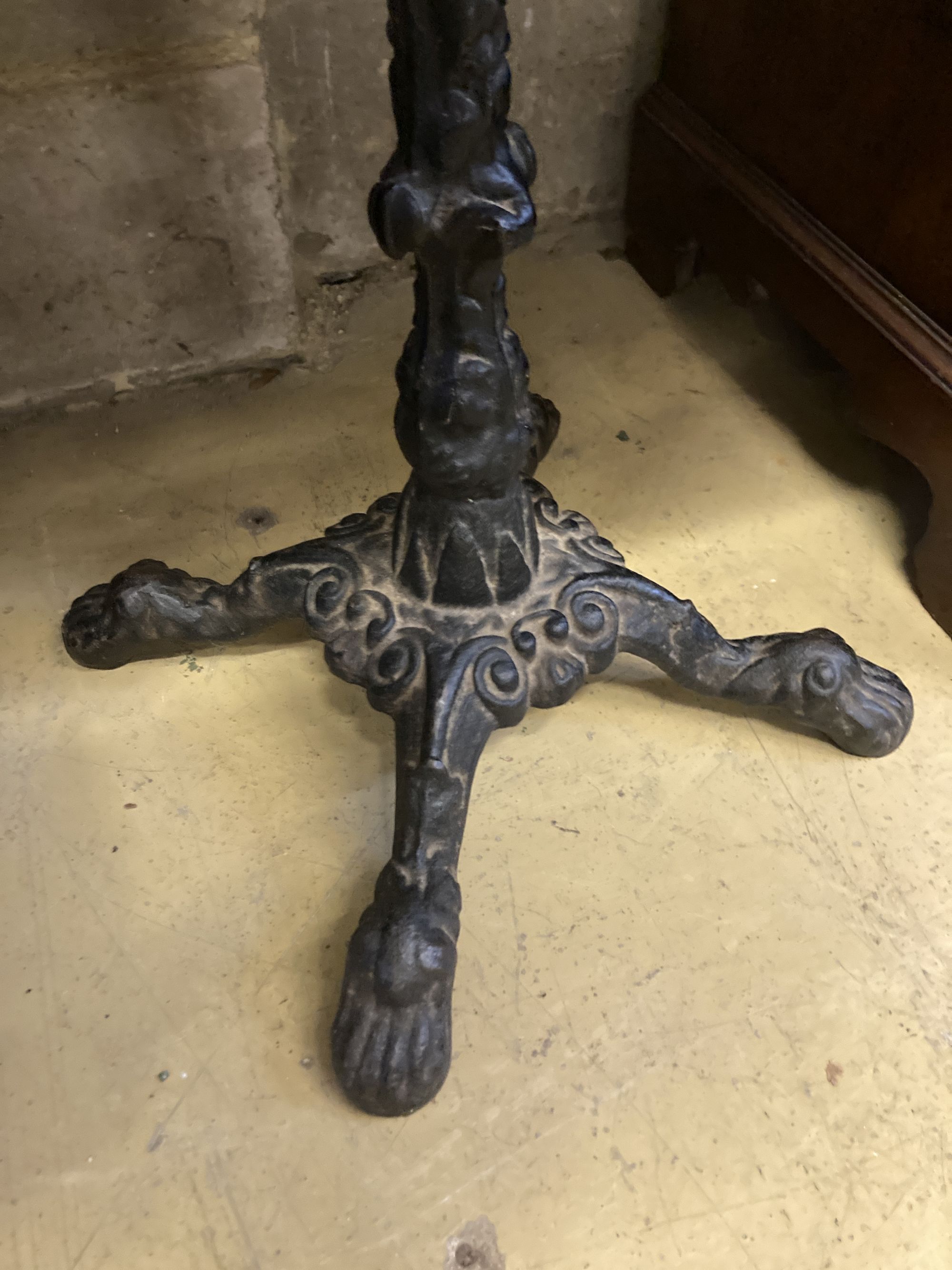 A Victorian style cast iron circular mahogany topped table, 58cm diameter, height 72cm